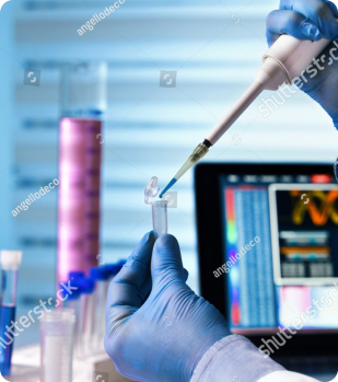 Researcher using a pipette beside coloured samples and a monitor