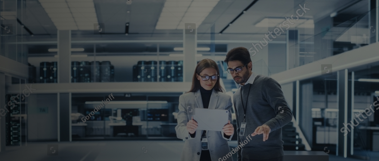 Two pharmaceutical professionals reviewing information on a tablet