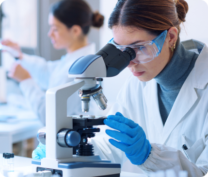 Scientist examining a sample through a microscope in a laboratory